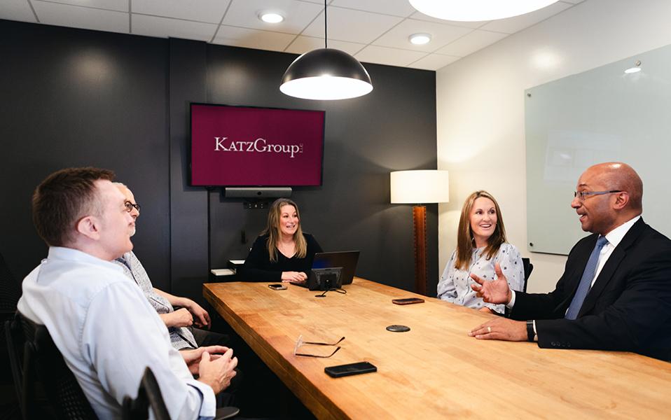 Julie A. Katz leading a meeting with five people around a conference table