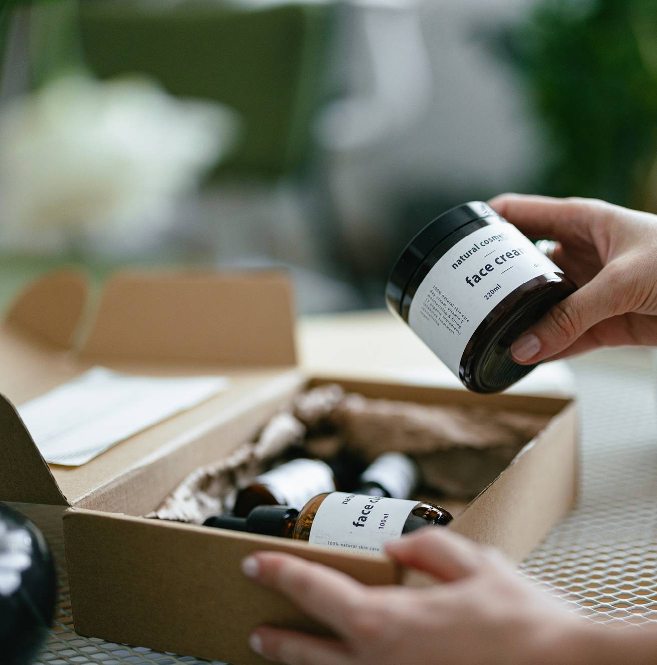 Hands unpacking a box of branded consumer products