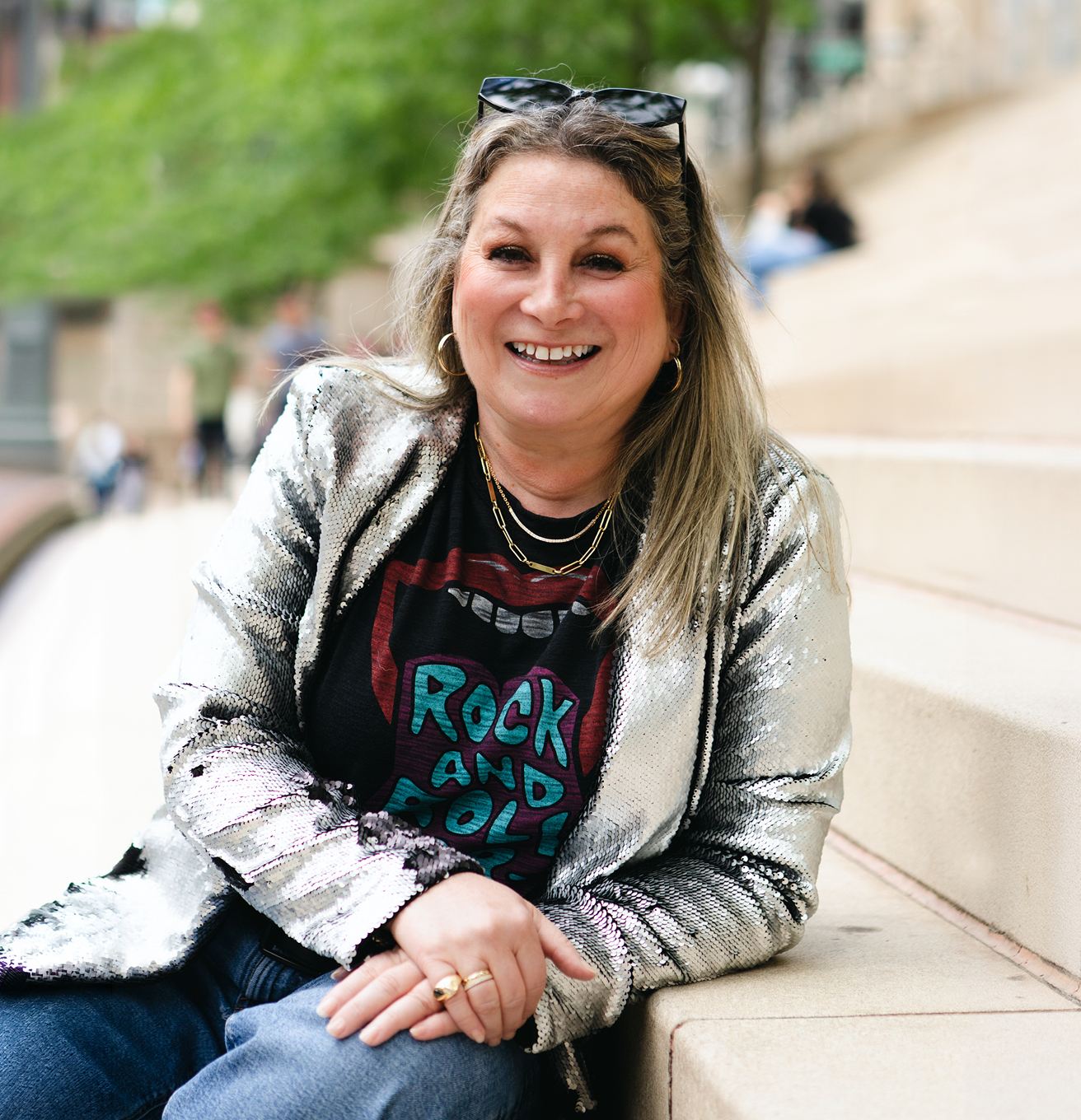 Portrait of Julie A. Katz smiling on the Chicago Riverwalk steps