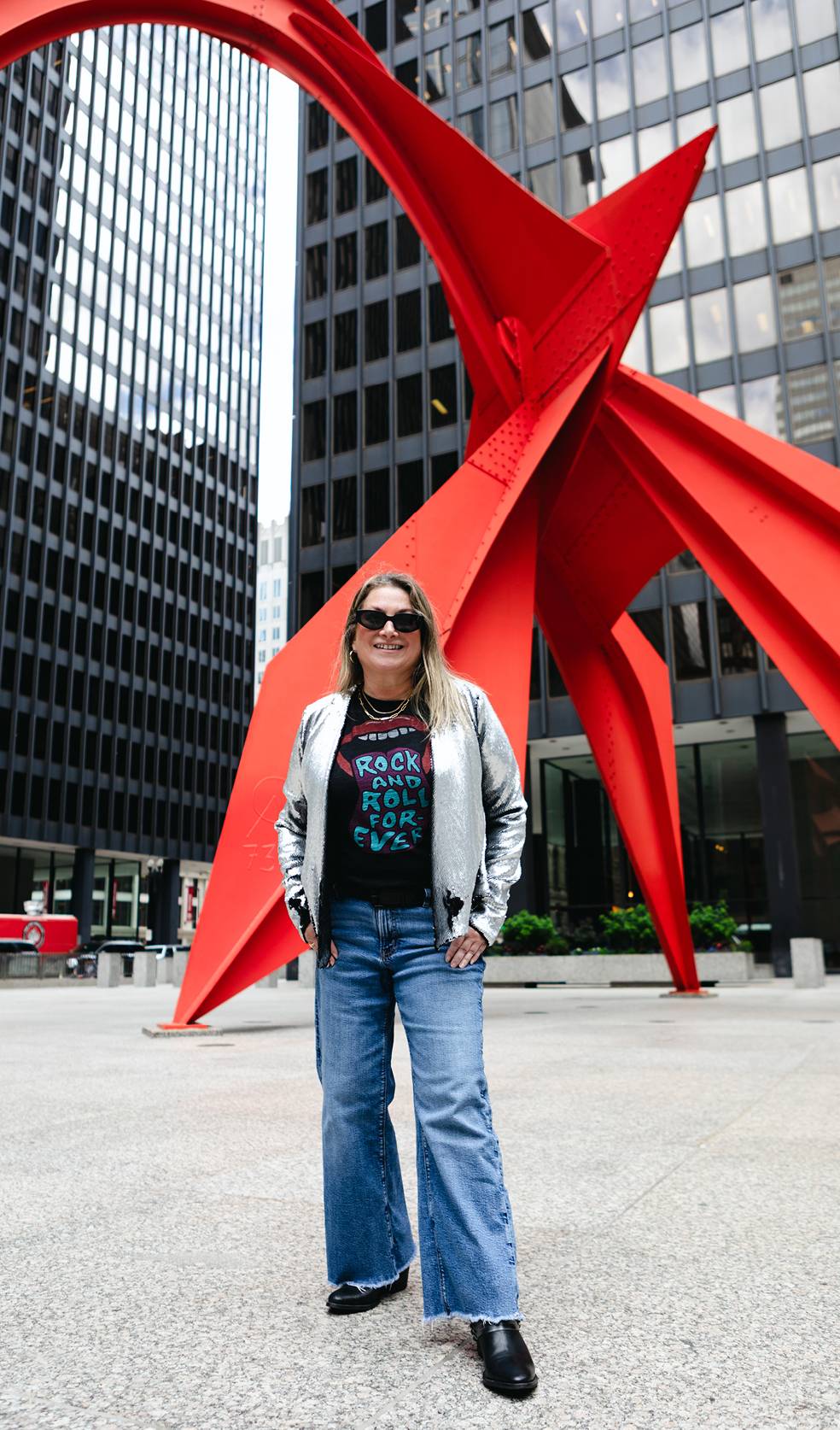 Julie A. Katz standing in front of the Calder Flamingo sculpture in Chicago