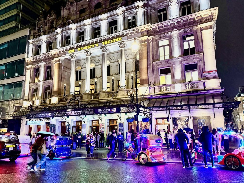 London theatre facade lit up at night