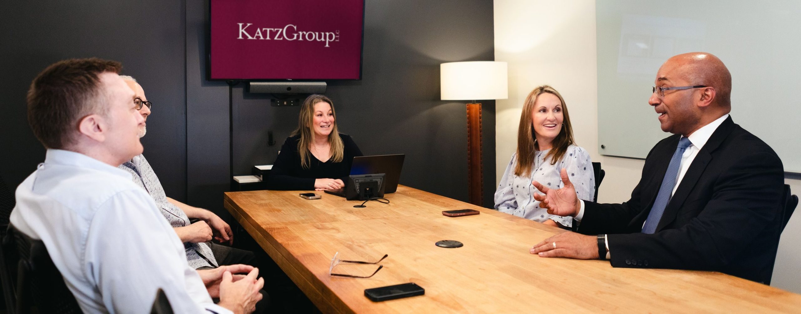 Julie A. Katz leading a meeting with five people around a conference table