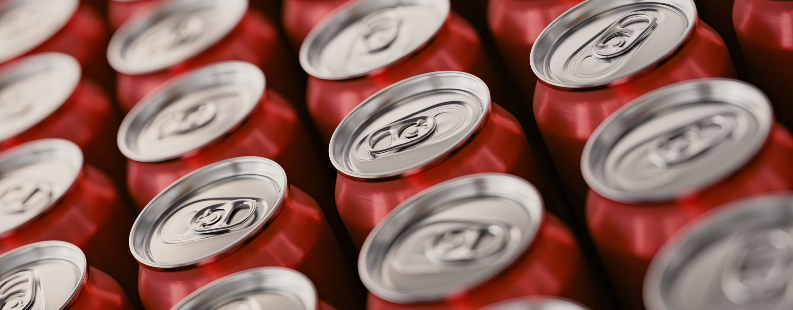 Rows of red aluminum soda cans with silver pull tabs