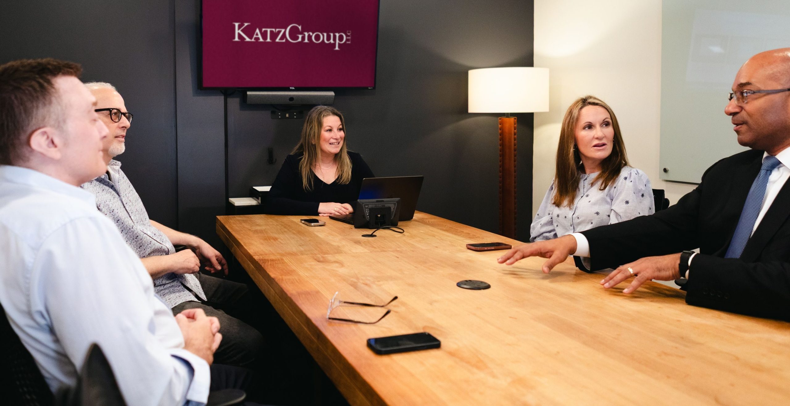 Julie A. Katz meeting with colleagues around a conference table at Katz Group